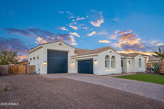 mediterranean / spanish-style home with a garage