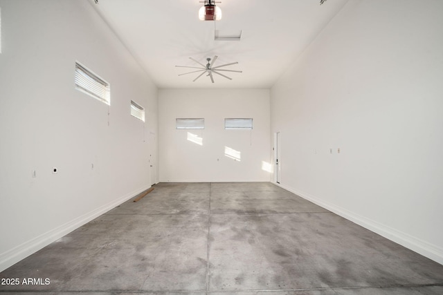 unfurnished room featuring ceiling fan and concrete flooring