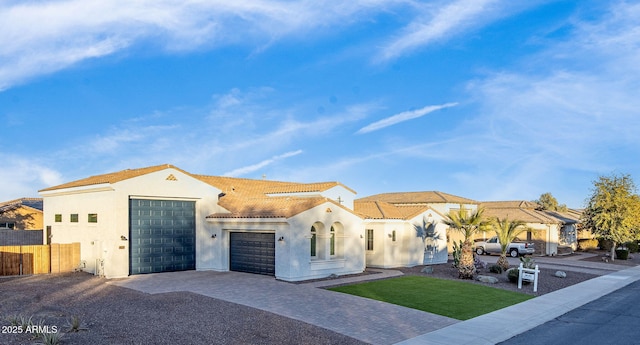 mediterranean / spanish-style house with a garage