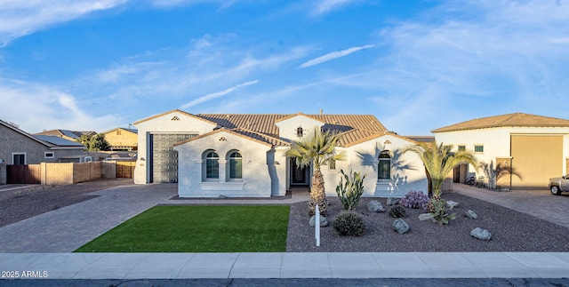 mediterranean / spanish home with a front yard