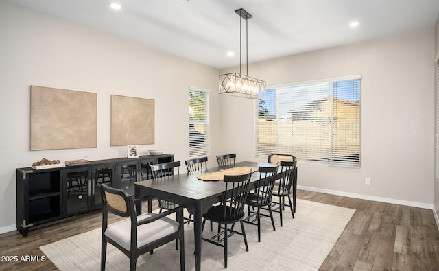 dining room featuring a healthy amount of sunlight and dark hardwood / wood-style floors