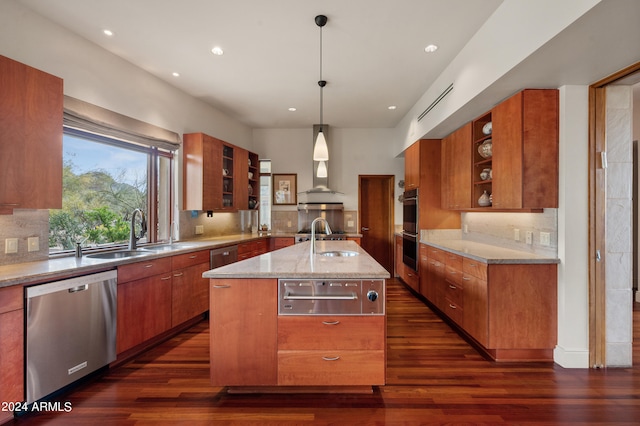 kitchen featuring brown cabinets, wall chimney exhaust hood, stainless steel appliances, and a warming drawer