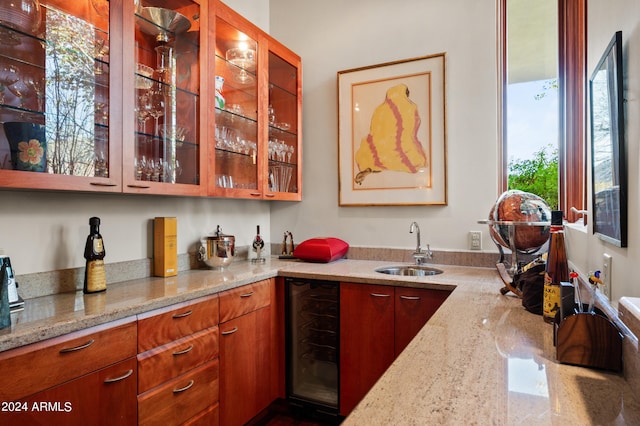 bar with wine cooler and a sink