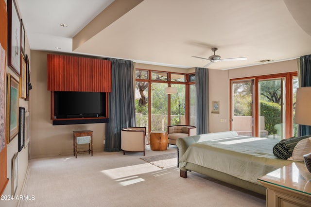 bedroom with access to exterior, light colored carpet, visible vents, and multiple windows