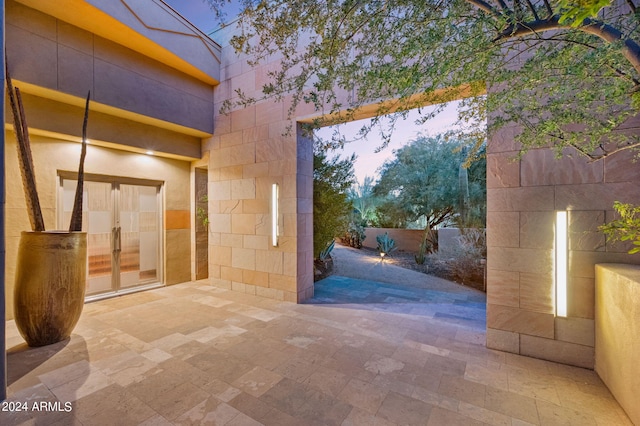 doorway to outside featuring tile walls