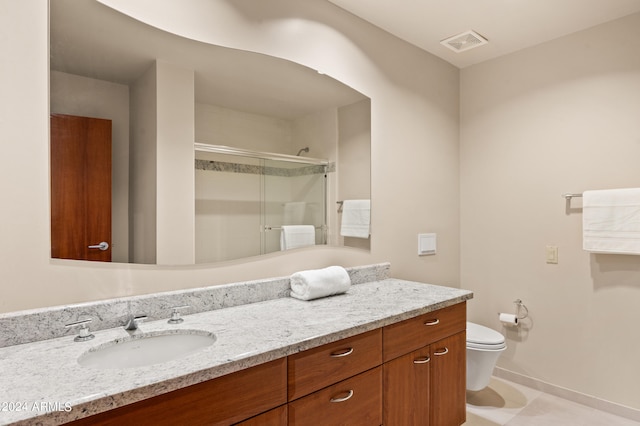 bathroom featuring visible vents, toilet, a stall shower, vanity, and baseboards