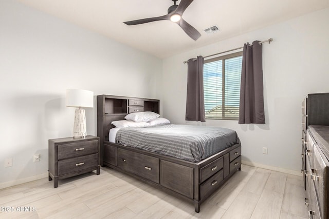 bedroom featuring light wood finished floors, baseboards, visible vents, and a ceiling fan