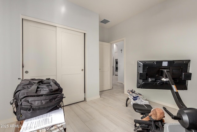 home office featuring light wood-style flooring, visible vents, and baseboards