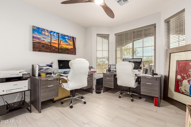 office area with visible vents and a ceiling fan