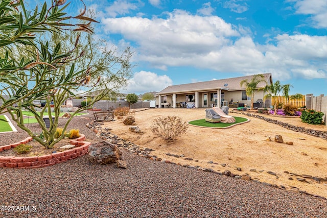 rear view of property with a patio and a fenced backyard