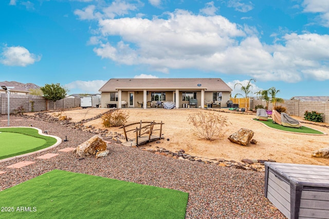 back of property featuring a fenced backyard, a patio, a tiled roof, and stucco siding