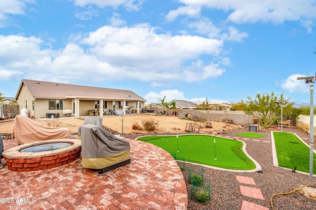 rear view of property with a patio area, a fenced backyard, and a jacuzzi