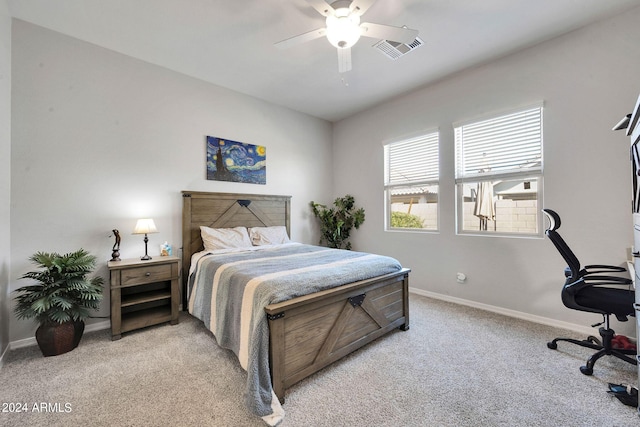 bedroom with baseboards, a ceiling fan, visible vents, and light colored carpet