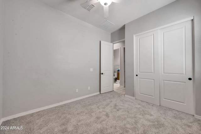 unfurnished bedroom featuring a closet, visible vents, a ceiling fan, carpet flooring, and baseboards