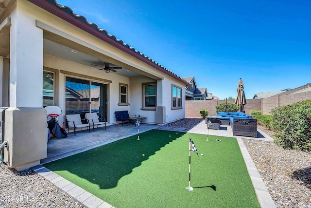 view of yard with an outdoor living space, a patio area, ceiling fan, and a fenced backyard