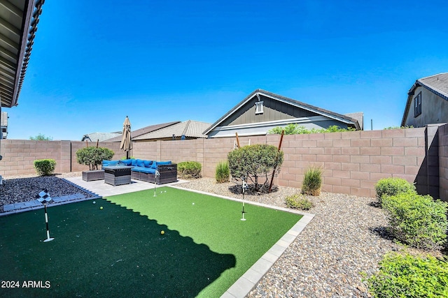 view of yard featuring a patio, outdoor lounge area, and a fenced backyard