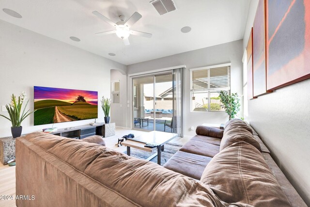 living room with wood-type flooring and ceiling fan