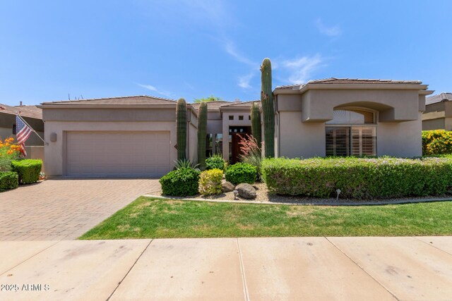8689 E Krail St, Scottsdale, AZ 85250 - view of front of property with an attached garage, driveway, and stucco siding
