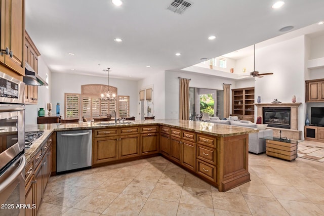 8689 E Krail St, Scottsdale, AZ 85250 - kitchen featuring stainless steel dishwasher, recessed lighting, brown cabinetry, a ceiling fan, and light stone counters