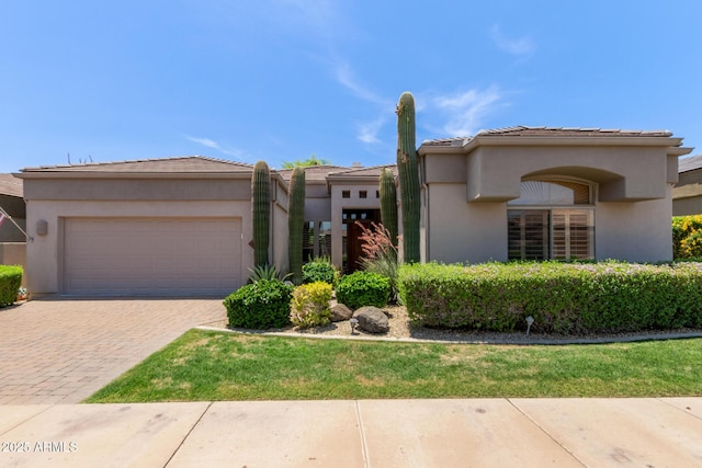 8689 E Krail St, Scottsdale, AZ 85250 - view of front of house featuring a garage, decorative driveway, stucco siding, and a tiled roof