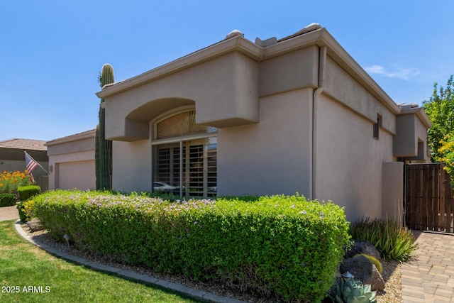 8689 E Krail St, Scottsdale, AZ 85250 - view of property exterior with a garage and stucco siding
