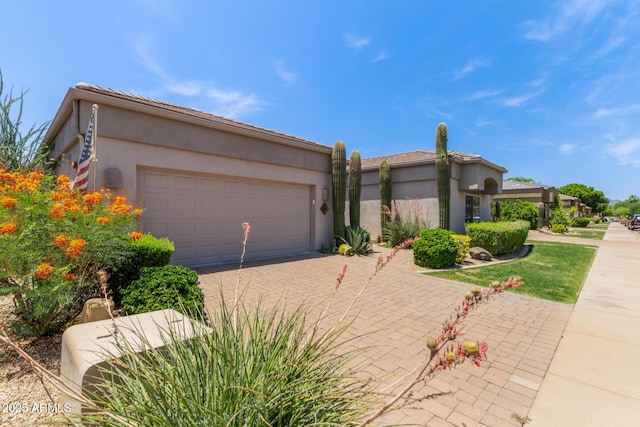 8689 E Krail St, Scottsdale, AZ 85250 - view of front of property featuring a garage, driveway, and stucco siding