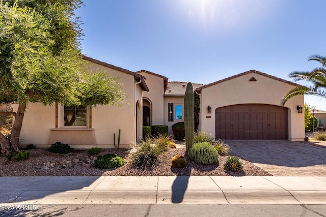 mediterranean / spanish-style home with a garage