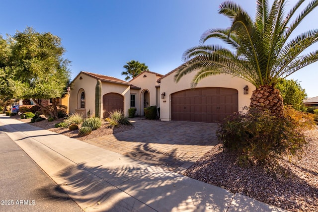 mediterranean / spanish home featuring a garage