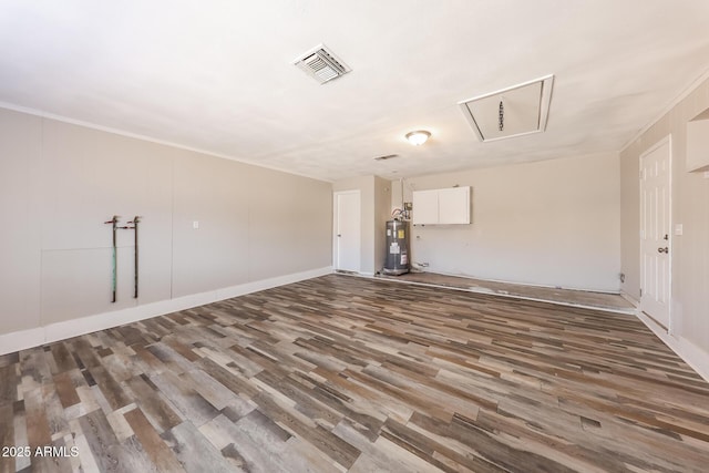 4833 N 63rd Ln, Phoenix, AZ 85033 - spare room featuring water heater, attic access, and wood finished floors