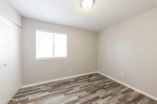 4833 N 63rd Ln, Phoenix, AZ 85033 - unfurnished bedroom featuring wood finished floors and a closet