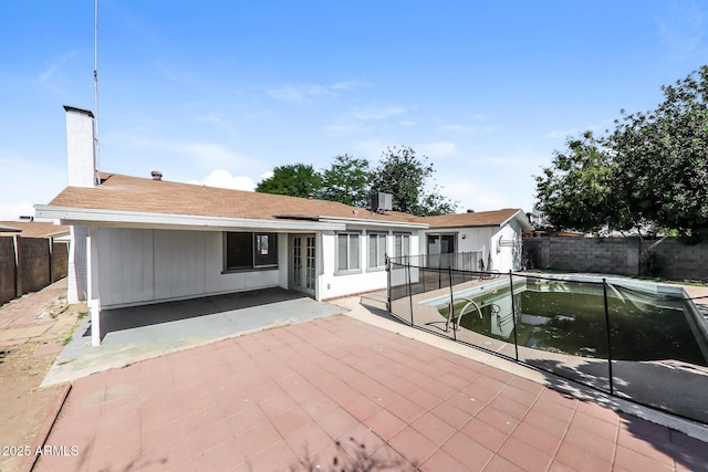 4833 N 63rd Ln, Phoenix, AZ 85033 - rear view of house featuring a patio, a fenced backyard, and a chimney