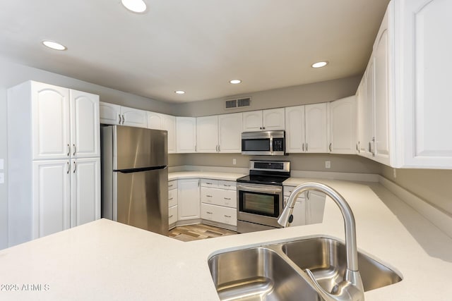 4833 N 63rd Ln, Phoenix, AZ 85033 - kitchen featuring stainless steel appliances, recessed lighting, light countertops, and white cabinetry