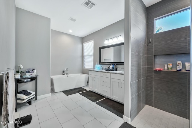 bathroom featuring tile patterned flooring, vanity, and separate shower and tub