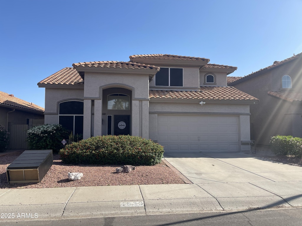 4633 E Desert Cactus St, Phoenix, AZ 85032 - mediterranean / spanish-style house featuring stucco siding, a tile roof, driveway, and an attached garage