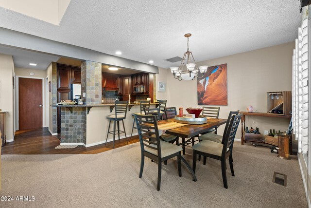2900 N Saddleback Way Unit 9, Flagstaff, AZ 86004 - dining space with carpet floors, a chandelier, a textured ceiling, and recessed lighting