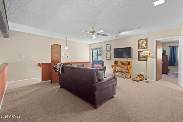 2900 N Saddleback Way Unit 9, Flagstaff, AZ 86004 - living room featuring light carpet, a textured ceiling, and a ceiling fan