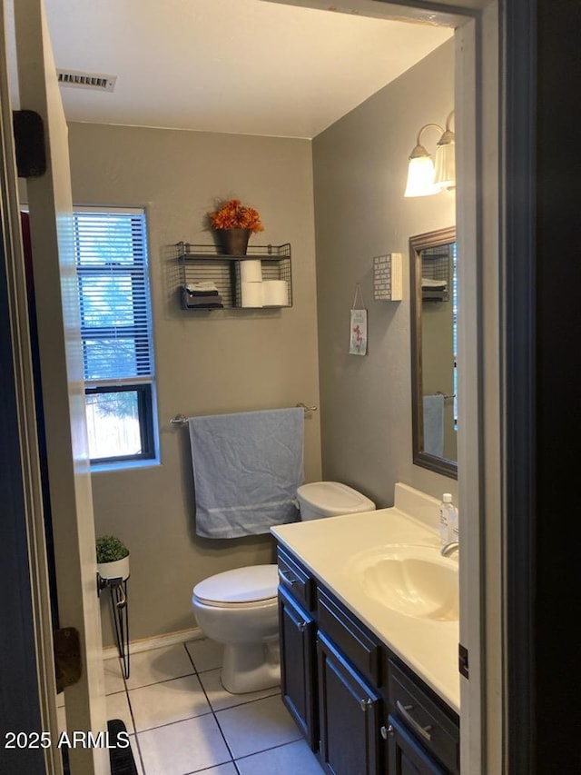 bathroom featuring tile patterned floors, vanity, and toilet