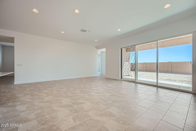 unfurnished room with recessed lighting and baseboards