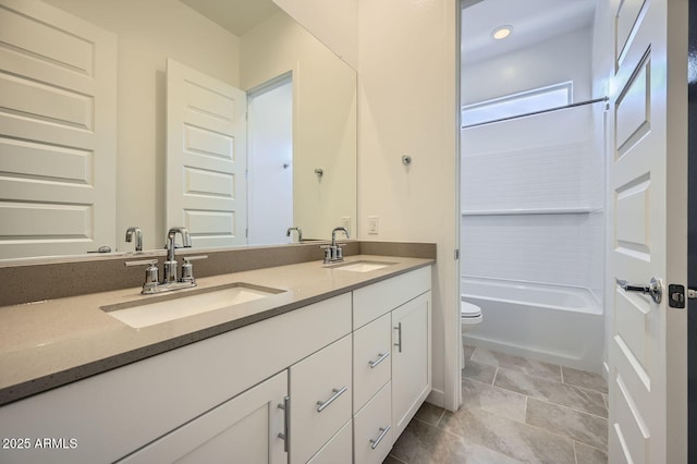full bath featuring toilet, double vanity, and washtub / shower combination