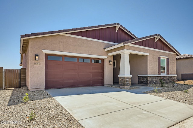 craftsman-style house featuring an attached garage, stucco siding, concrete driveway, a tiled roof, and stone siding