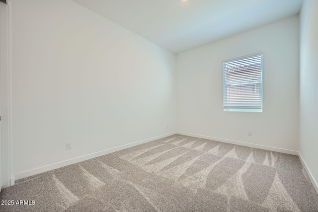 carpeted spare room with baseboards