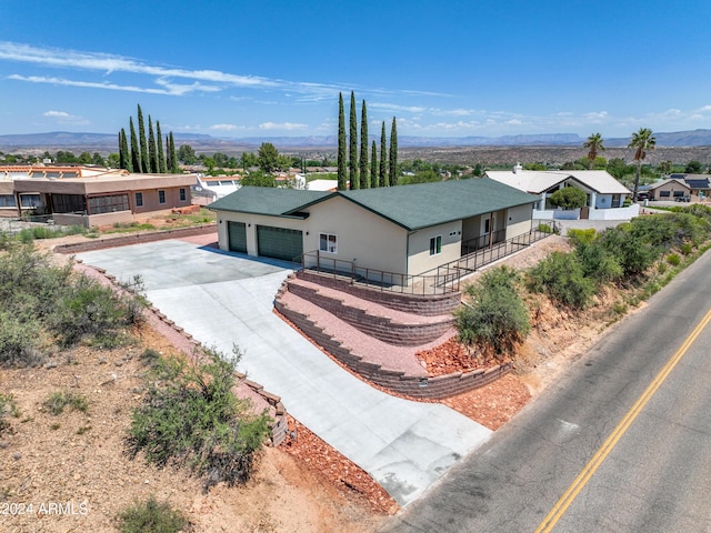 ranch-style home with a garage and a mountain view