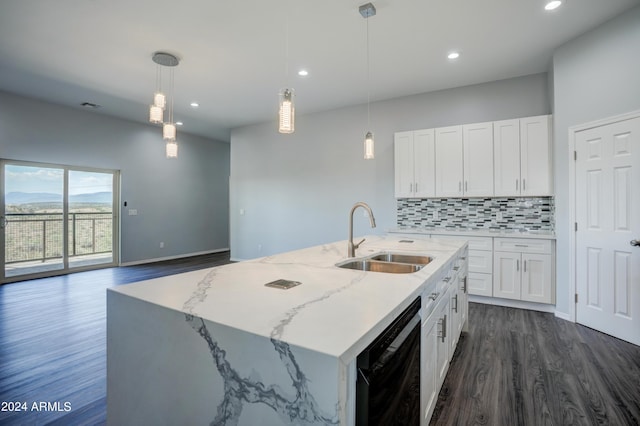 kitchen with an island with sink, decorative light fixtures, sink, and white cabinets