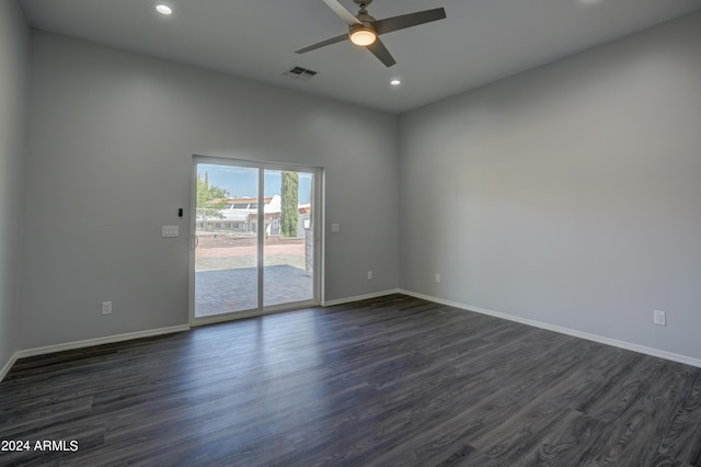 spare room with dark wood-type flooring and ceiling fan