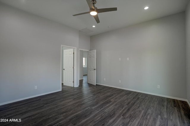 empty room featuring dark wood-type flooring and ceiling fan