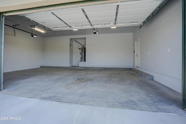 garage featuring a garage door opener and water heater