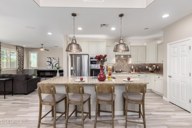 5407 S Tatum Ln, Gilbert, AZ 85298 - kitchen featuring appliances with stainless steel finishes, under cabinet range hood, decorative backsplash, recessed lighting, and ceiling fan