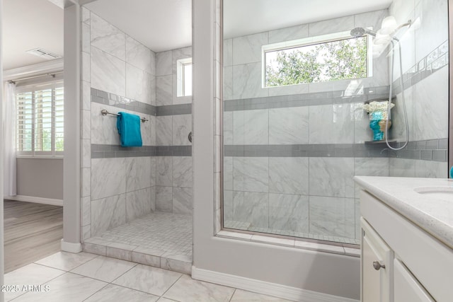 5407 S Tatum Ln, Gilbert, AZ 85298 - bathroom featuring tiled shower, baseboards, healthy amount of natural light, and vanity