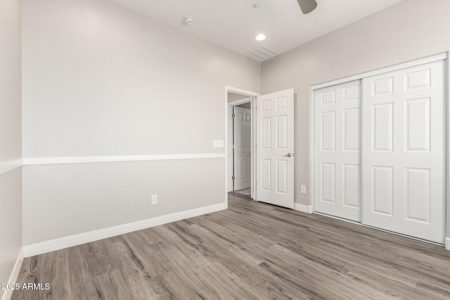 5407 S Tatum Ln, Gilbert, AZ 85298 - unfurnished bedroom featuring wood finished floors, baseboards, a closet, and a ceiling fan