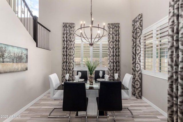 5407 S Tatum Ln, Gilbert, AZ 85298 - dining room with a chandelier, light wood-type flooring, baseboards, and a high ceiling